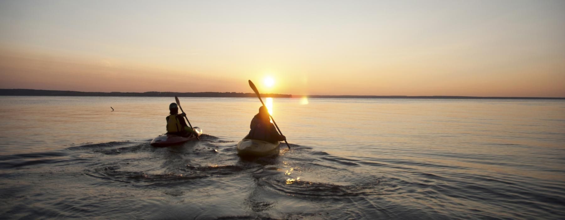two people in boats on the water