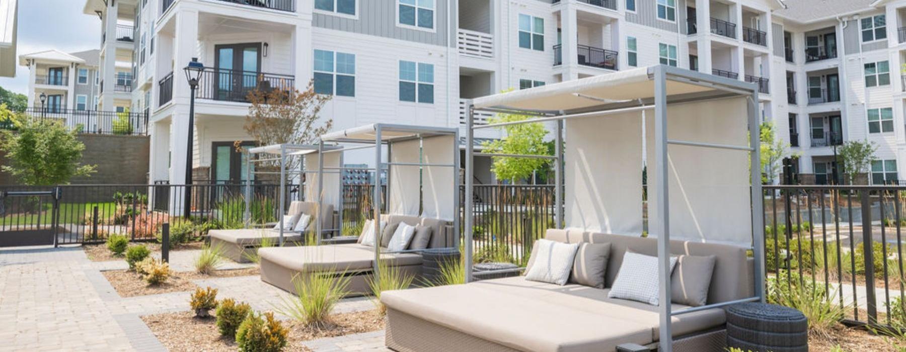 a large white building with a patio and a large patio